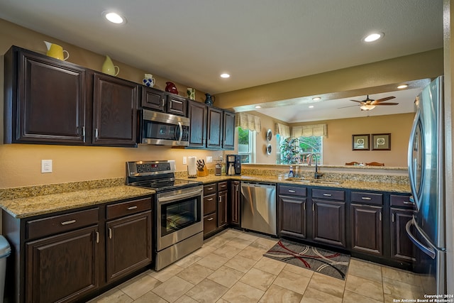 kitchen featuring dark brown cabinets, appliances with stainless steel finishes, ceiling fan, sink, and kitchen peninsula