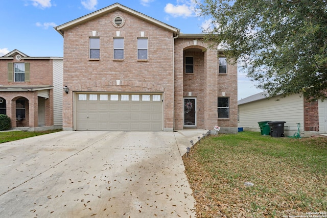 view of property with a front yard and a garage