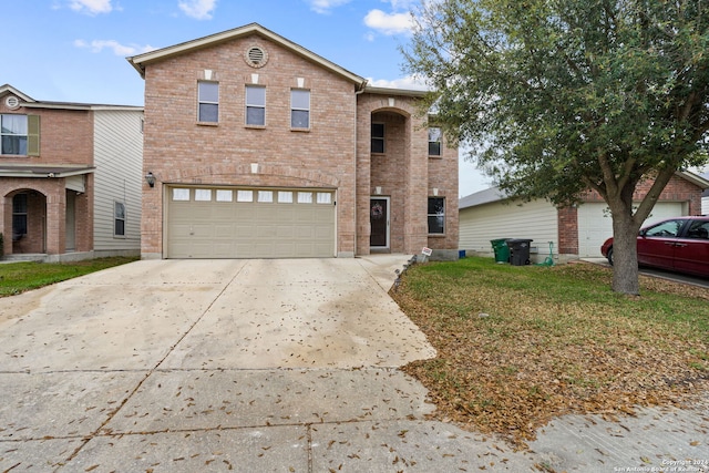 front facade featuring a front lawn and a garage