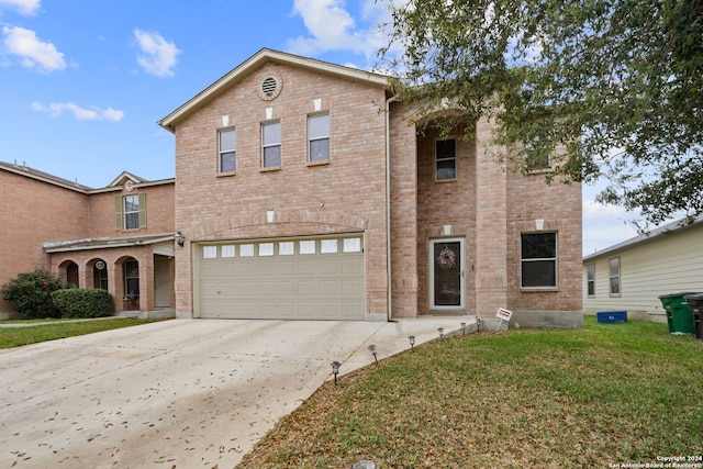 front facade featuring a front yard and a garage