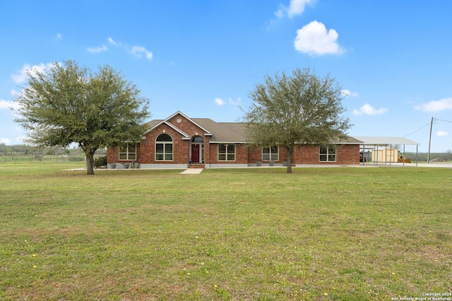 ranch-style home featuring a front lawn and a carport