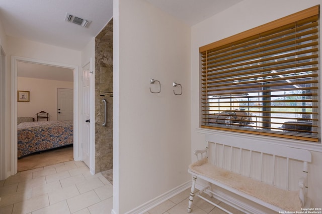 hall featuring radiator and light tile patterned flooring