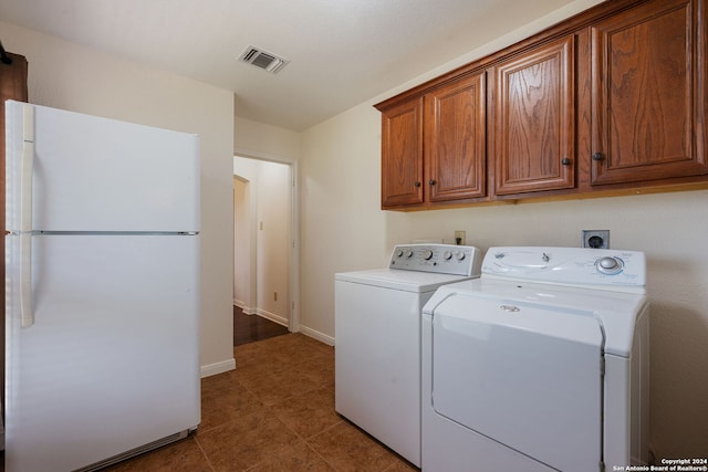 laundry room featuring cabinets, tile patterned floors, and washer and clothes dryer