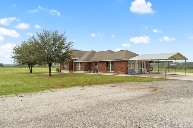 view of front facade with a front yard and a carport