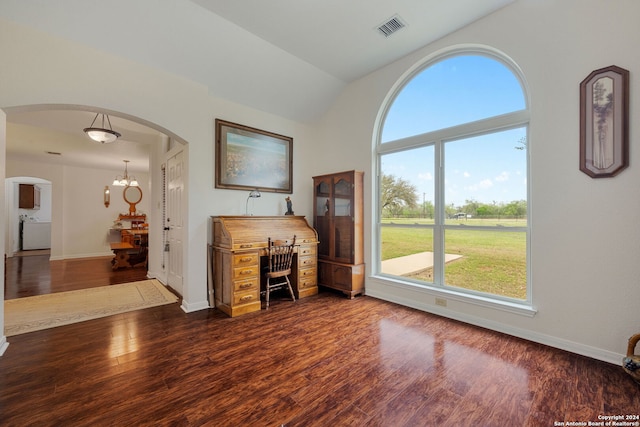 living room with vaulted ceiling, a chandelier, and dark hardwood / wood-style floors