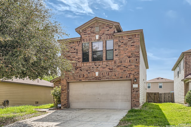 front of property featuring a front yard and a garage