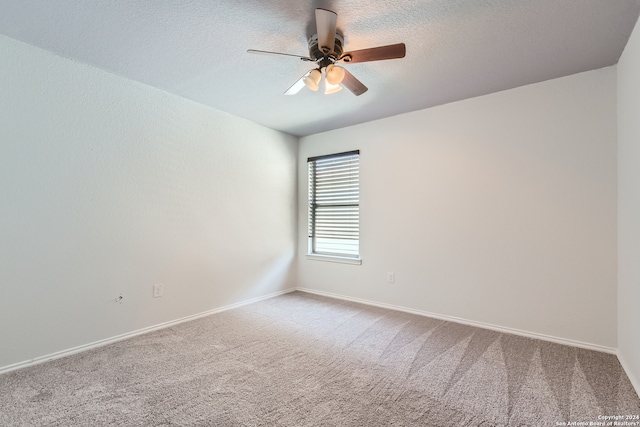 carpeted empty room with a textured ceiling and ceiling fan