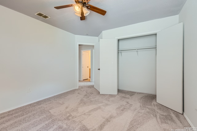 unfurnished bedroom with a closet, ceiling fan, and light colored carpet