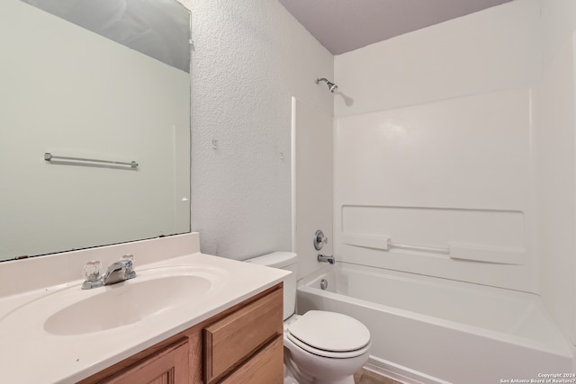 full bathroom featuring toilet, vanity, and bathtub / shower combination