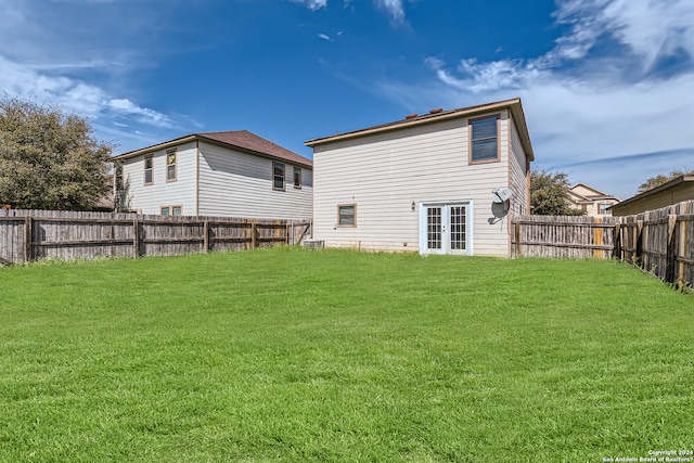 rear view of house with a yard