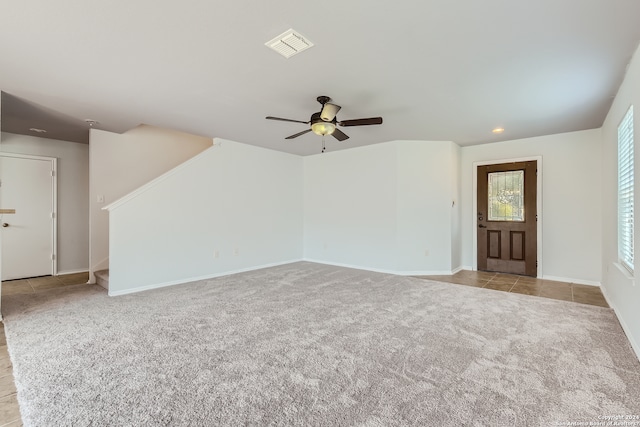 unfurnished room with ceiling fan and light carpet