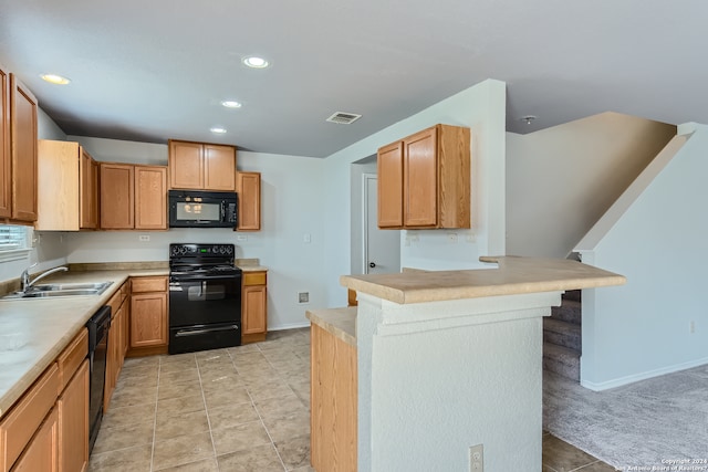 kitchen with a kitchen breakfast bar, sink, kitchen peninsula, light carpet, and black appliances