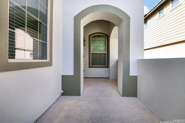 view of exterior entry featuring a patio area