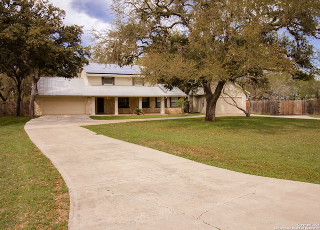 view of front facade featuring a garage and a front yard