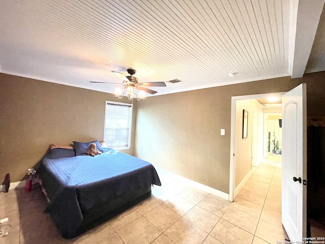 tiled bedroom featuring ceiling fan