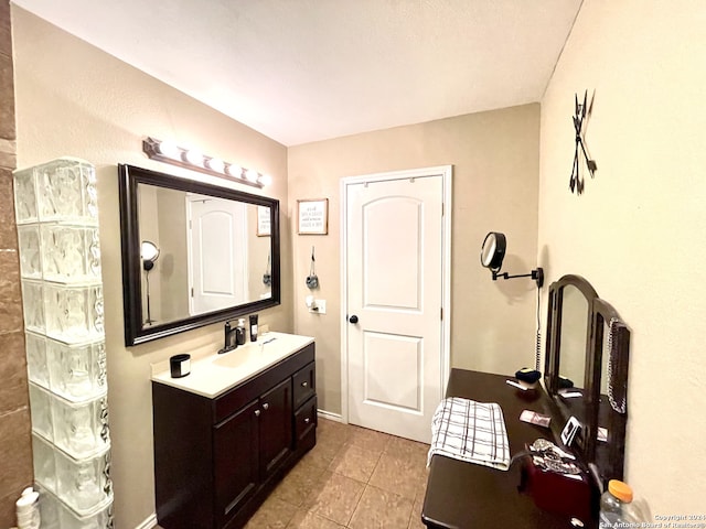 bathroom with tile floors and vanity with extensive cabinet space