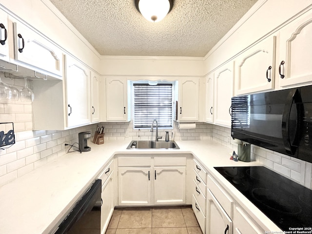 kitchen with white cabinetry, tasteful backsplash, black appliances, and sink