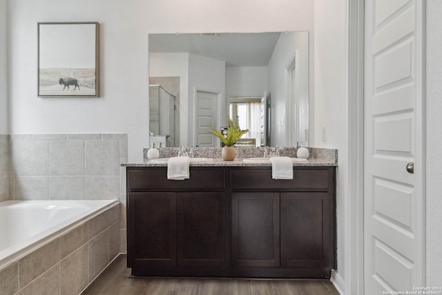 bathroom with vanity, wood-type flooring, and independent shower and bath