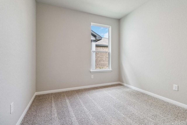 carpeted spare room featuring a wealth of natural light