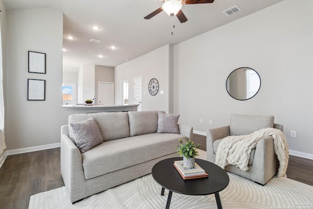 living room featuring hardwood / wood-style floors and ceiling fan