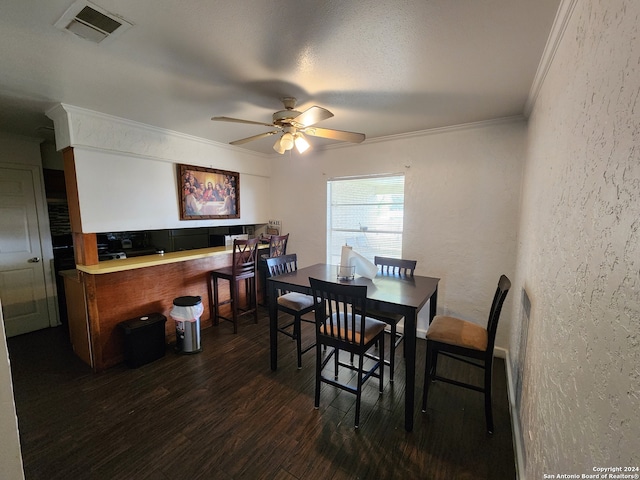 dining room with ceiling fan, dark hardwood / wood-style floors, and crown molding