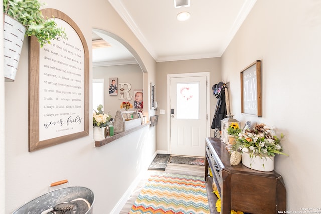 entrance foyer with wood-type flooring and crown molding