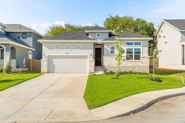 view of front of property with a front lawn and a garage