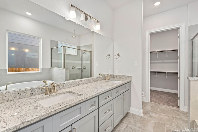 full bathroom with shower with separate bathtub, toilet, double vanity, and tile flooring