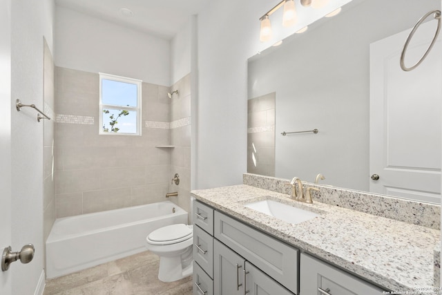 full bathroom with tiled shower / bath combo, toilet, vanity with extensive cabinet space, and tile flooring