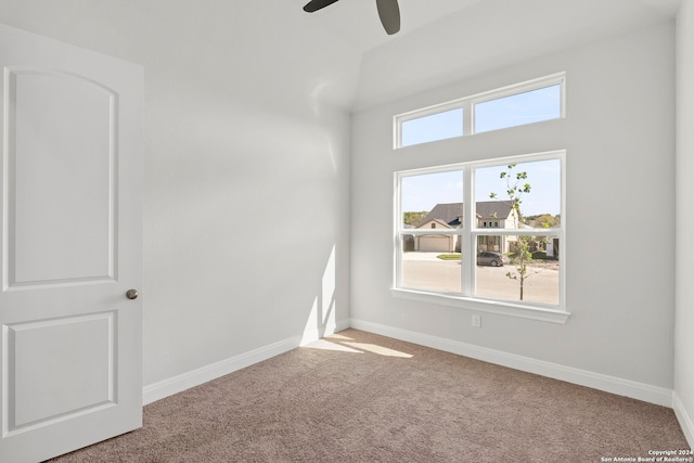 empty room featuring ceiling fan, a healthy amount of sunlight, and light colored carpet