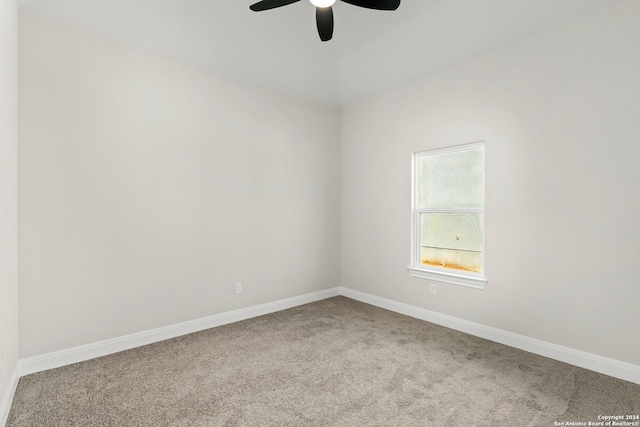 spare room with light colored carpet and ceiling fan