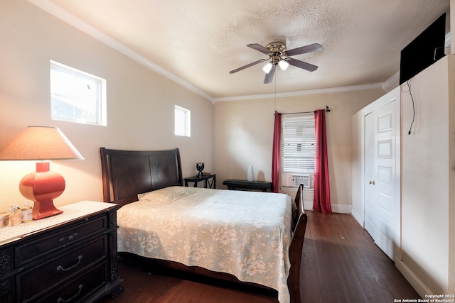 bedroom featuring ceiling fan, dark wood-type flooring, a textured ceiling, and crown molding