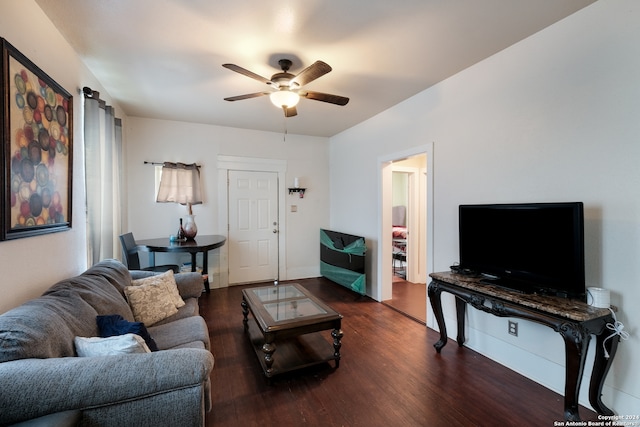 living room with dark wood-type flooring and ceiling fan