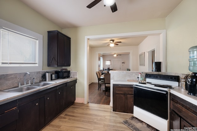 kitchen featuring backsplash, ceiling fan, sink, light hardwood / wood-style flooring, and white range with electric cooktop