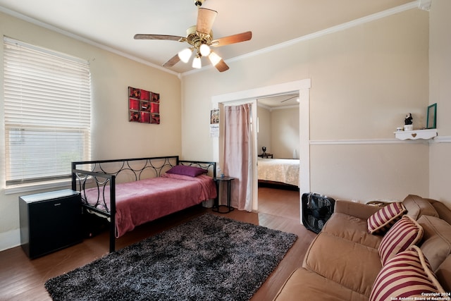 bedroom featuring ceiling fan, crown molding, hardwood / wood-style floors, and a closet