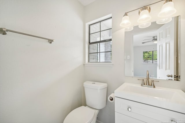 bathroom with ceiling fan, vanity, and toilet
