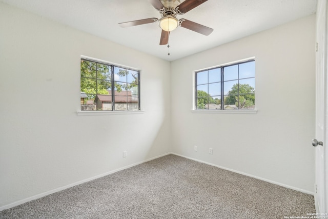 carpeted spare room featuring ceiling fan