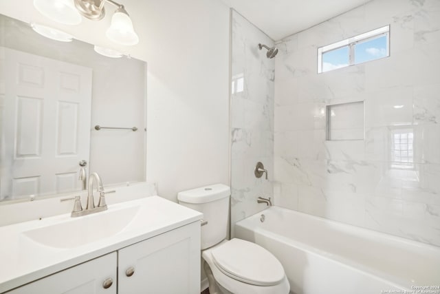 full bathroom featuring vanity, toilet, and tiled shower / bath combo