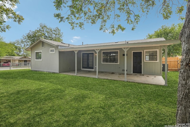 rear view of house with a patio area and a lawn