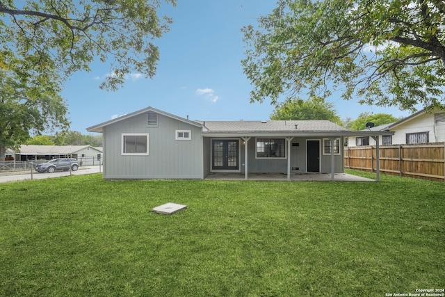 back of property featuring a lawn and a patio area