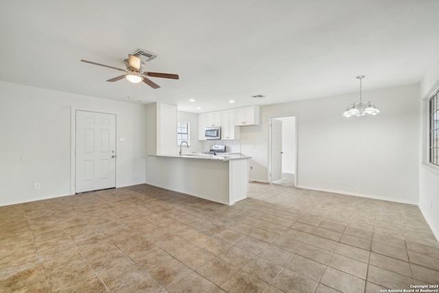 unfurnished living room featuring light tile patterned floors and ceiling fan with notable chandelier