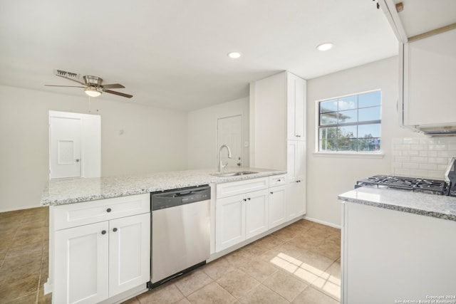 kitchen featuring white cabinetry, kitchen peninsula, light stone counters, and stainless steel appliances