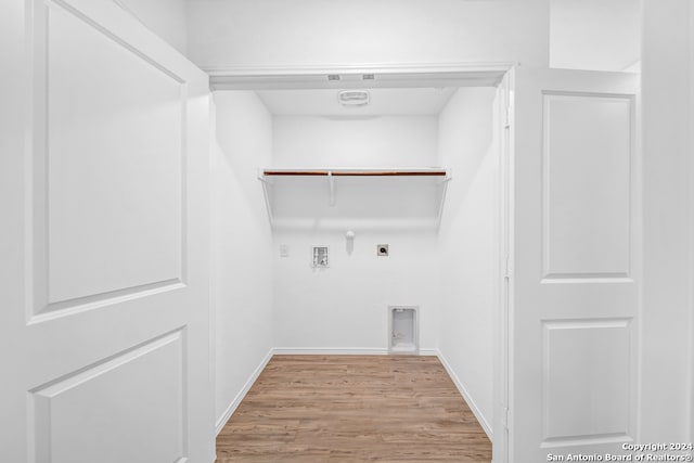 washroom featuring electric dryer hookup, hookup for a gas dryer, light wood-type flooring, and hookup for a washing machine