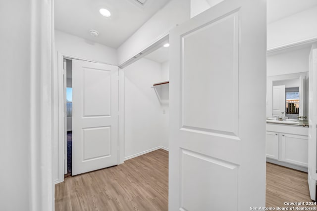 walk in closet featuring light hardwood / wood-style flooring