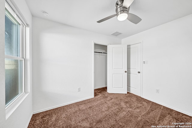 unfurnished bedroom with multiple windows, ceiling fan, and carpet floors