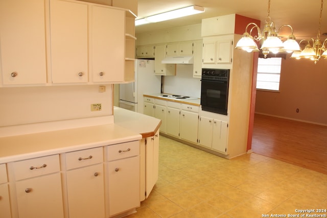 kitchen with a chandelier, light tile floors, hanging light fixtures, and white appliances