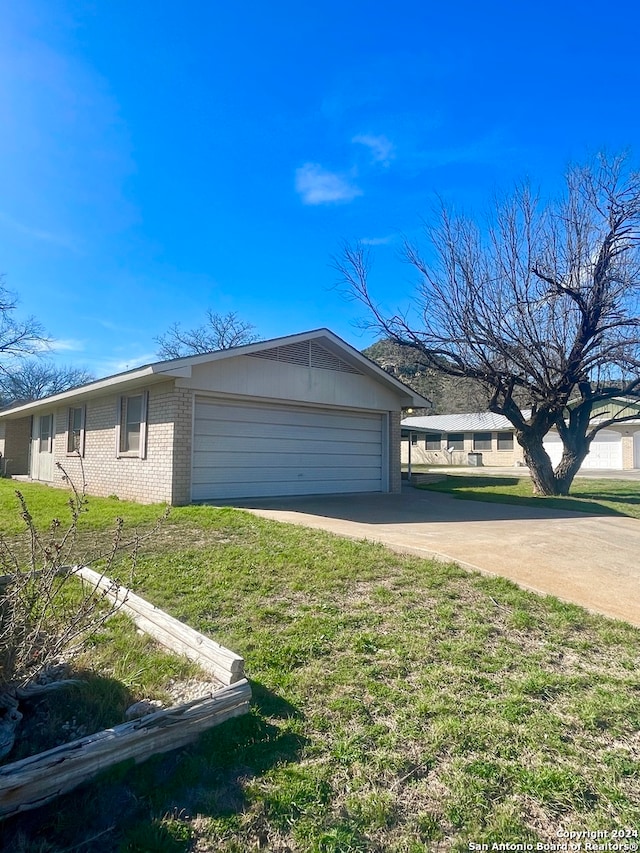 exterior space with a front yard and a garage