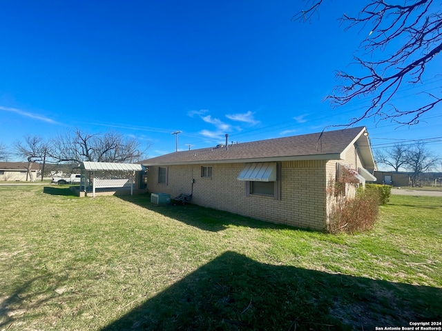 view of side of home with a yard