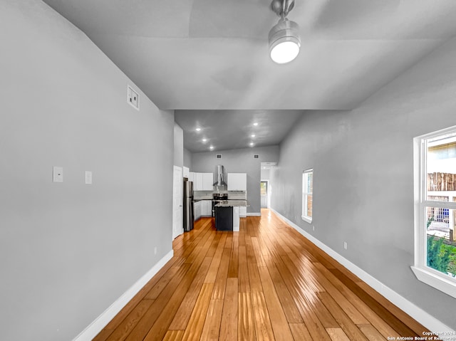 corridor with light wood-type flooring