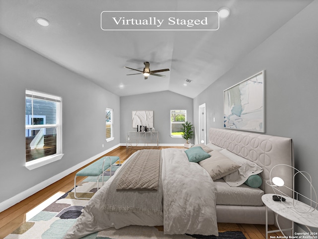 bedroom featuring multiple windows, ceiling fan, and hardwood / wood-style flooring